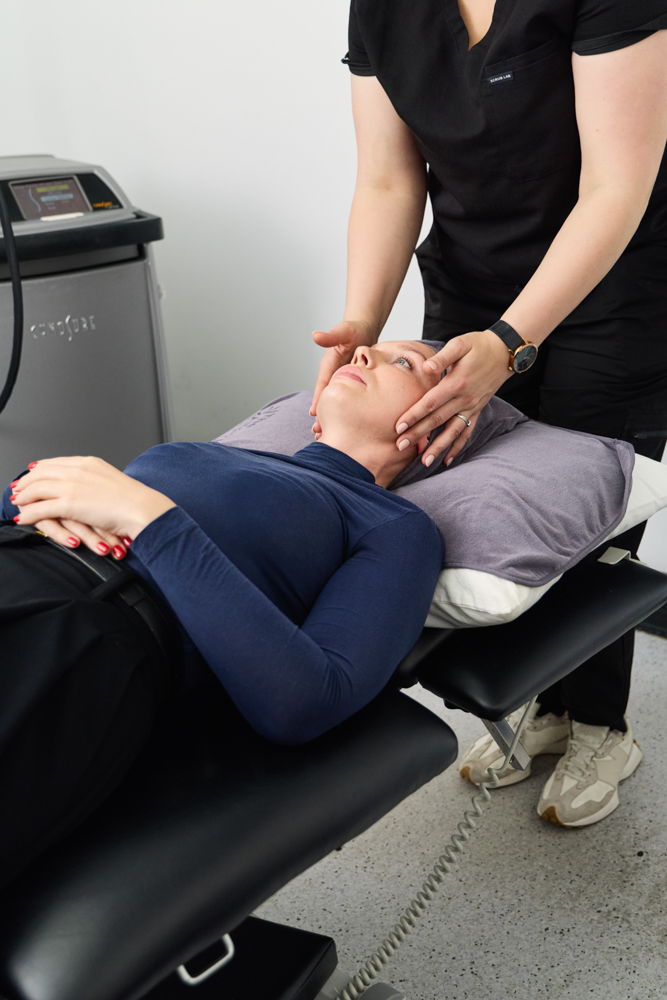 Clinician performing a facial treatment at The Aesthetic Laser Centre